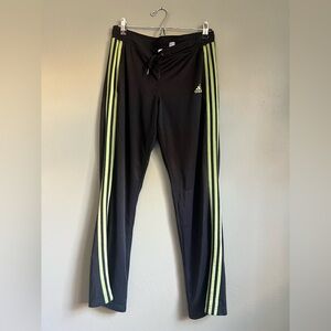 Black and green adidas track pants